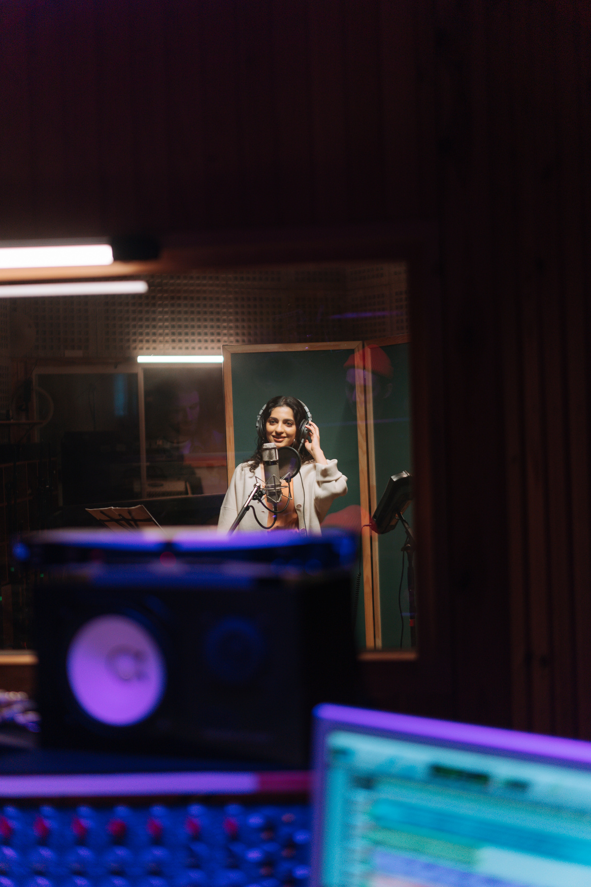 A Woman Wearing Headphones Inside the Music Studio